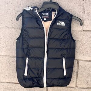The North Face brand kids vest with pockets.